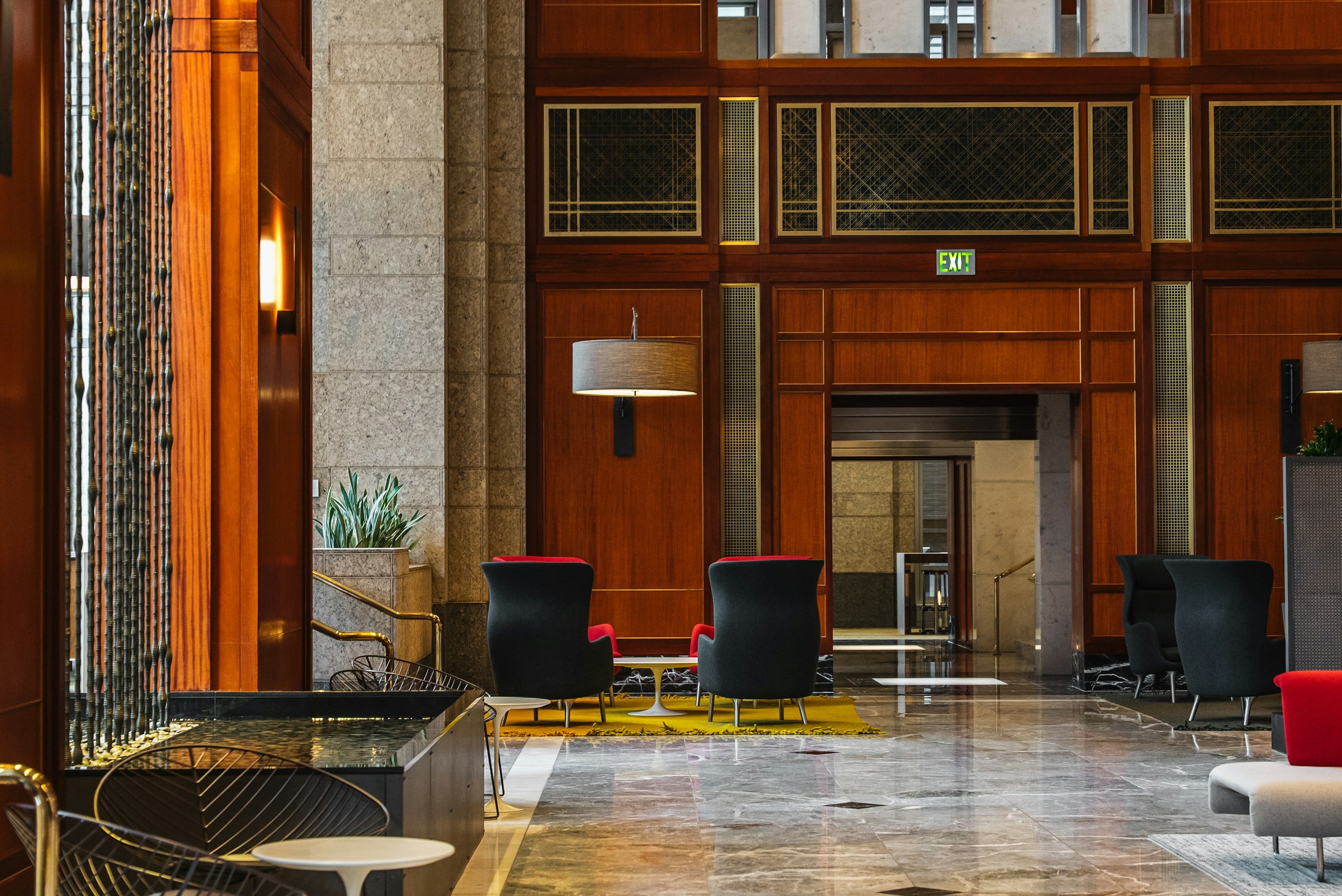 Ahşap kaplamalı, zarif oturma gruplarıyla bir otel lobisi